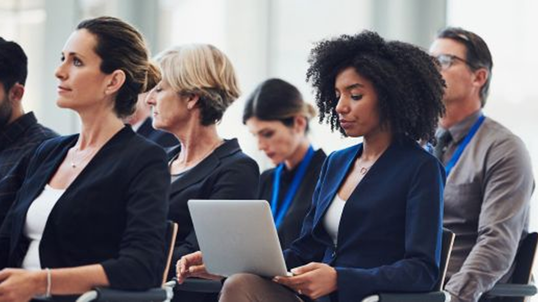 Professionals attending a workforce development presentation